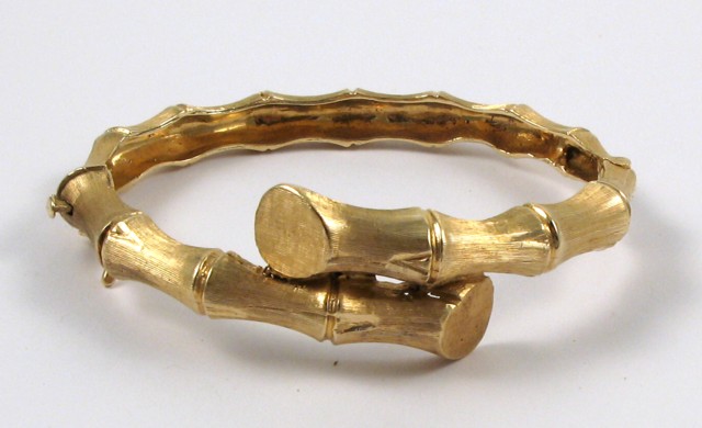 Appraisal: FOURTEEN KARAT YELLOW GOLD BANGLE The oval hinged bangle weighs