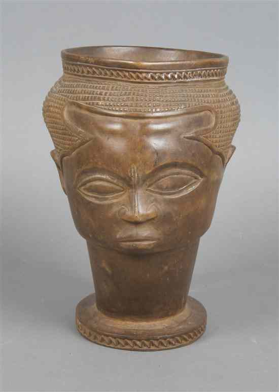 Appraisal: A Carved Wood Libation Cup Kuba with carved face decoration