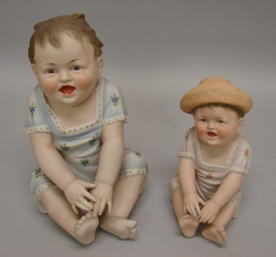 Appraisal: -Piano Figurines of sitting children Unmarked pair of similar children