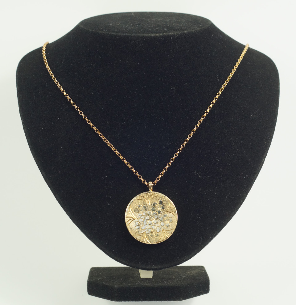 Appraisal: A ct gold circular cased photo locket floral engraved on