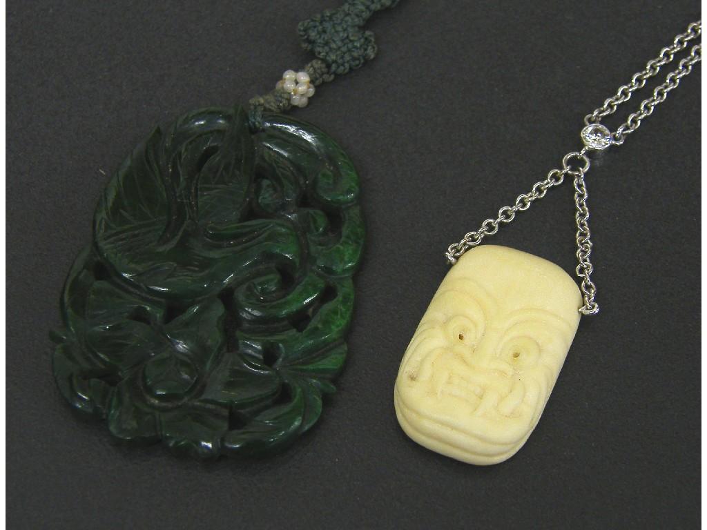 Appraisal: Unusual ivory grotesque mask pendant on a white metal chain