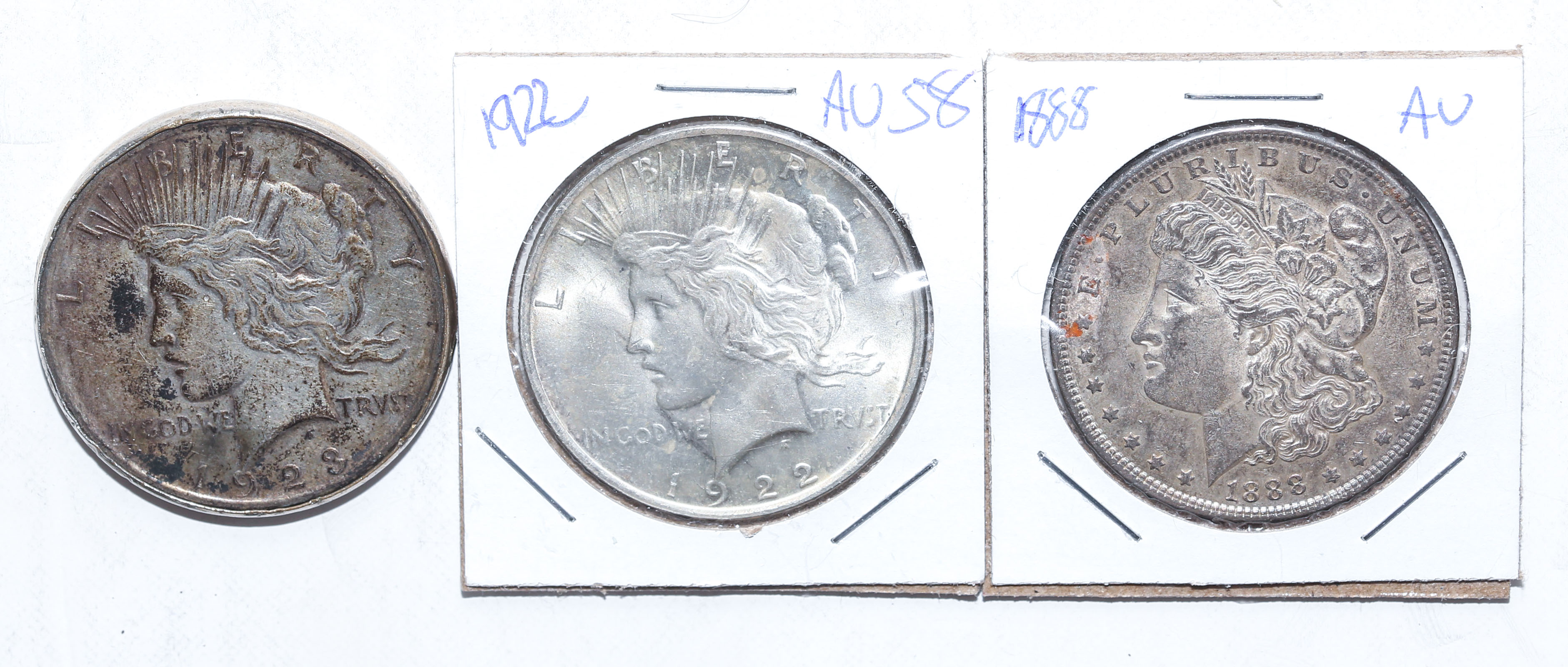 Appraisal: THREE US SILVER DOLLARS AU AU VF in bezel