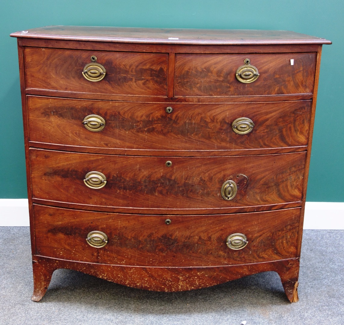 Appraisal: A George III mahogany bowfront chest of three short and