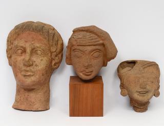 Appraisal: GROUP OF THREE STONE HEADS Comprising sandstone head on a