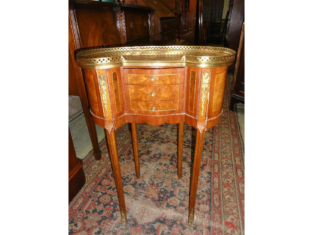 Appraisal: A continental walnut kidney shaped side occasional table with pierced