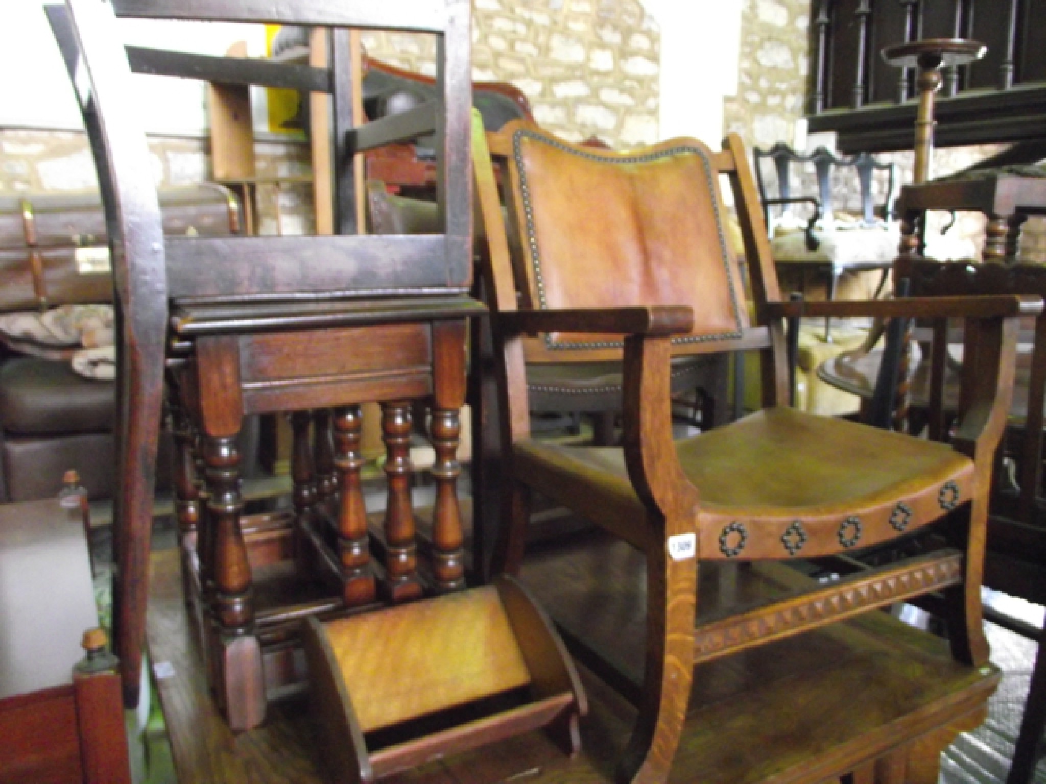 Appraisal: A s oak framed fireside chair with hide upholstered seat