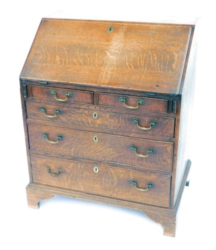 Appraisal: A George II oak bureau with fall flap resting on