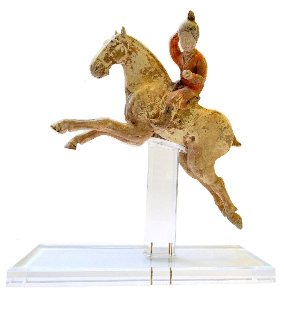 Appraisal: A Tang style pottery female polo player seated astride a