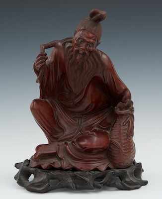 Appraisal: A Carved Wood Figure of a Seated Yamabushi with Basket