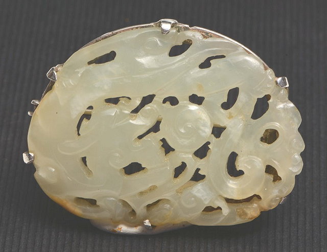 Appraisal: A CHINESE JADE AND MOUNTED BROOCH carved in the form