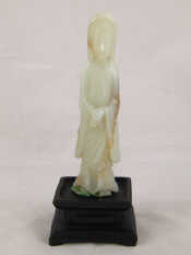 Appraisal: A Chinese jade carving approx cm high on a wooden