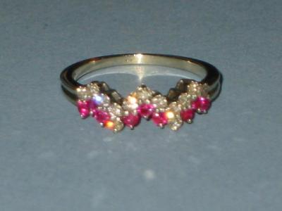 Appraisal: A RUBY AND DIAMOND RING the top set with round