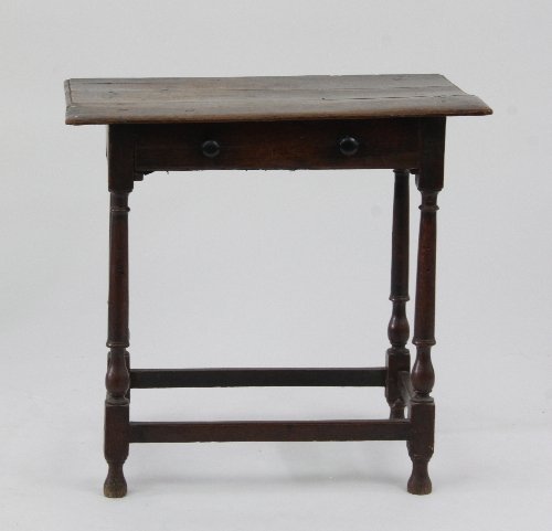 Appraisal: An th Century oak one-drawer long side table on turned