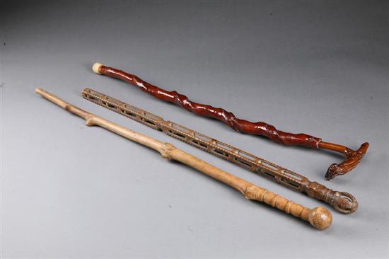 Appraisal: THREE FOLK ART CANES American early th century wood Whimsey