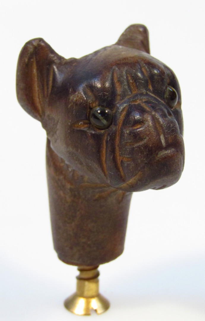 Appraisal: A polished cane head formed as a mastiff with carved