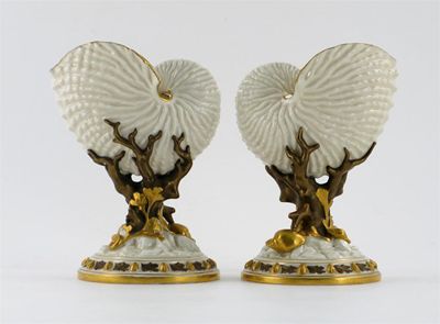 Appraisal: A pair of Royal Worcester Nautilus shell vases raised on