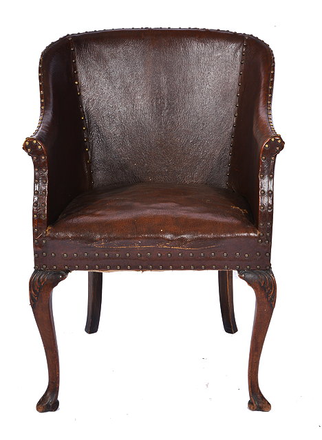 Appraisal: A LEATHER TUB ARMCHAIR with brass upholstery studs and standing