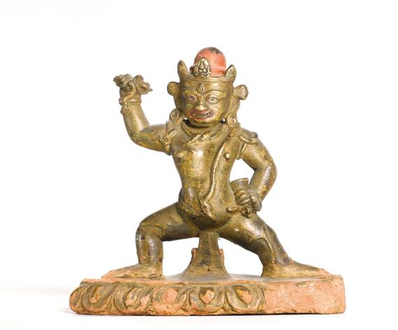 Appraisal: A BRONZE VAJRAPANI ON A CERAMIC STAND Tibet th c