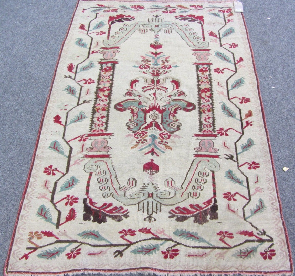 Appraisal: An Anatolian rug the ivory field with a central elongated