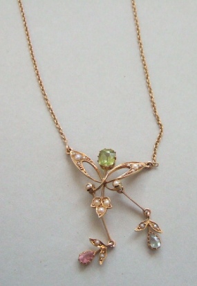 Appraisal: A gold half pearl peridot and gemstone set pendant necklace