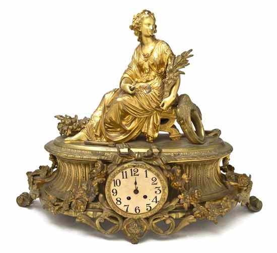 Appraisal: A French Gilt Bronze Figural Mantel Clock surmounted with a