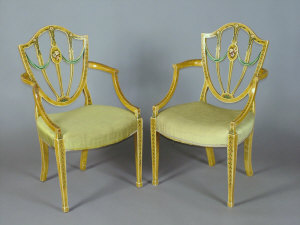 Appraisal: A pair of George III painted shield back armchairs in