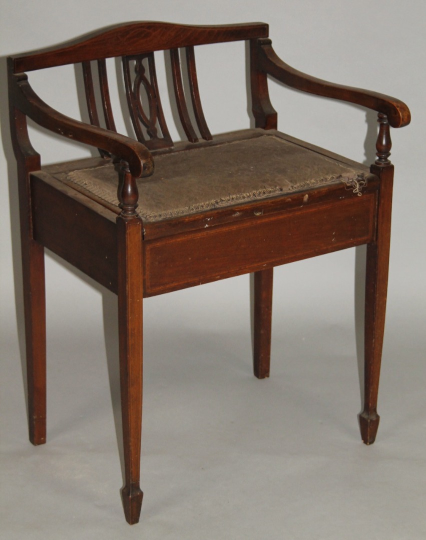 Appraisal: An Edwardian mahogany piano stool with a shaped back and