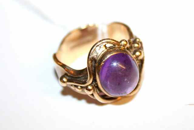 Appraisal: A CONTEMPORARY AMETHYST SET DRESS RING of abstract form in