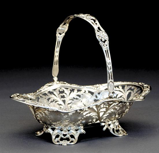 Appraisal: American silver footed basket pierced swing handle on conforming reticulated