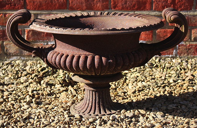 Appraisal: AN OLD CAST IRON URN of shallow campana form with