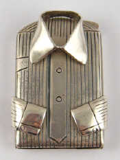 Appraisal: A silver pill box in the shape of a folded