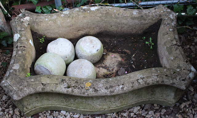 Appraisal: A RECTANGULAR SERPENTINE RECONSTITUTED STONE SHALLOW GARDEN PLANTER with concave