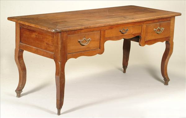 Appraisal: A French provincial chestnut three-drawer kneehole writing table late th