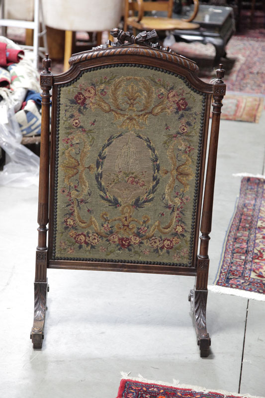 Appraisal: FRAMED NEEDLEPOINT FIRESCREEN Victorian carved mahogany firescreen with wool needlepoint