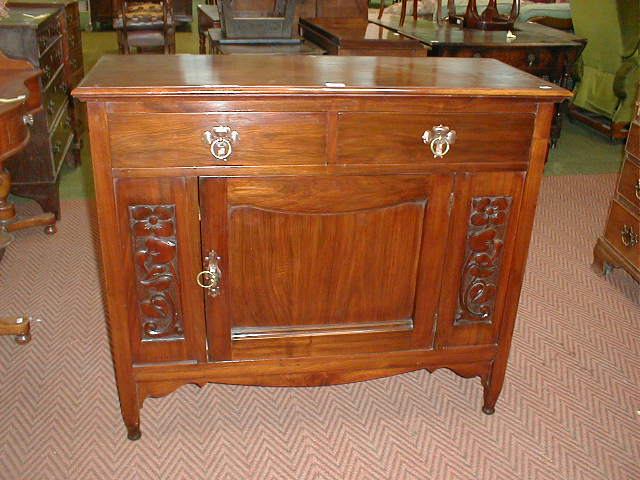 Appraisal: An Arts and Crafts walnut side cabinet wide