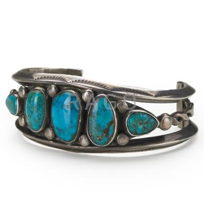 Appraisal: NAVAJO SILVER AND TURQUOISE BRACELET Twisted wire and carinated bands