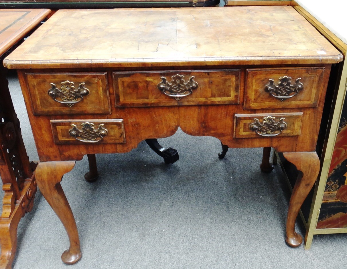 Appraisal: An early th century walnut lowboy with quarter veneered and