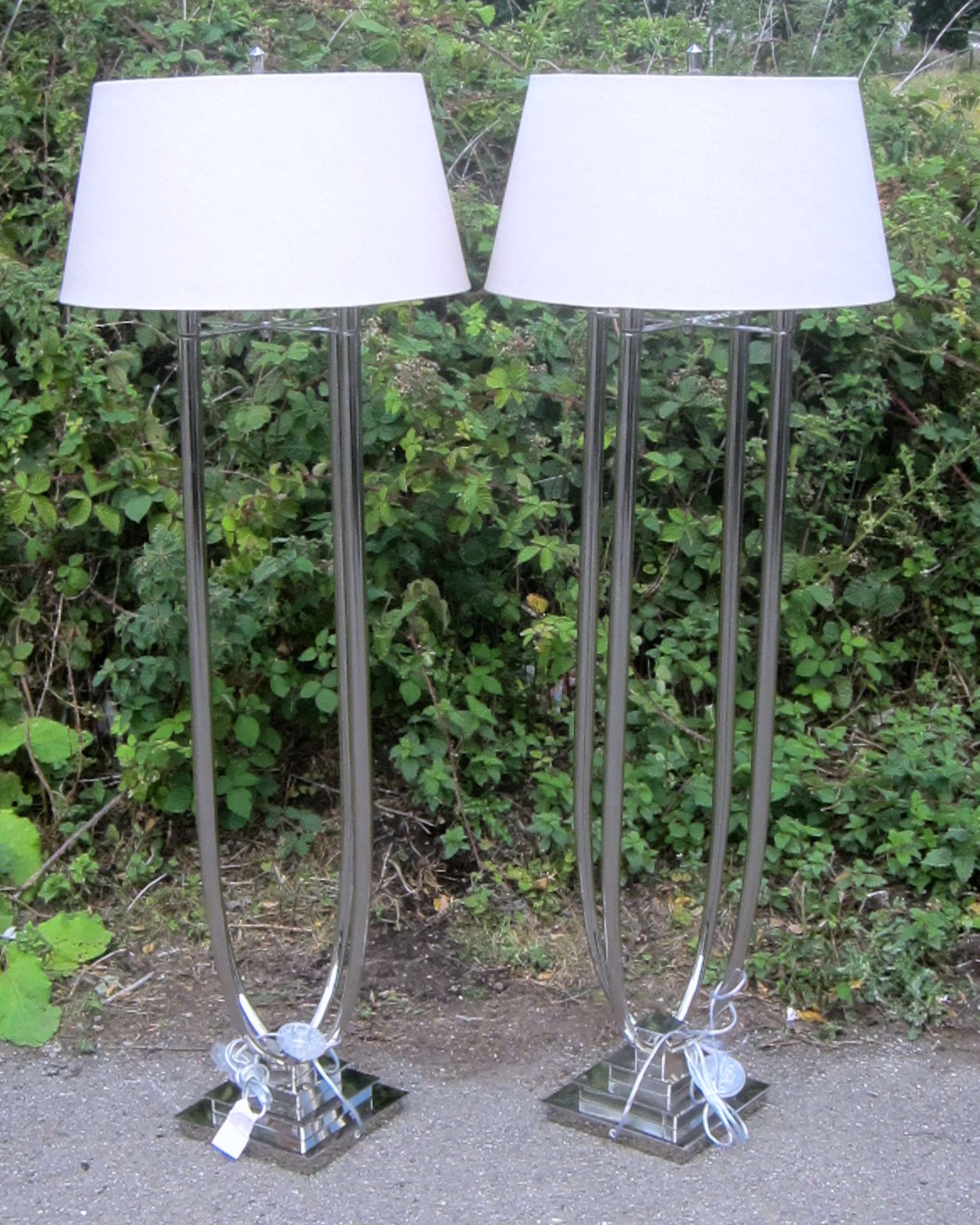 Appraisal: Pair of chrome standard lamps and a pair of matching