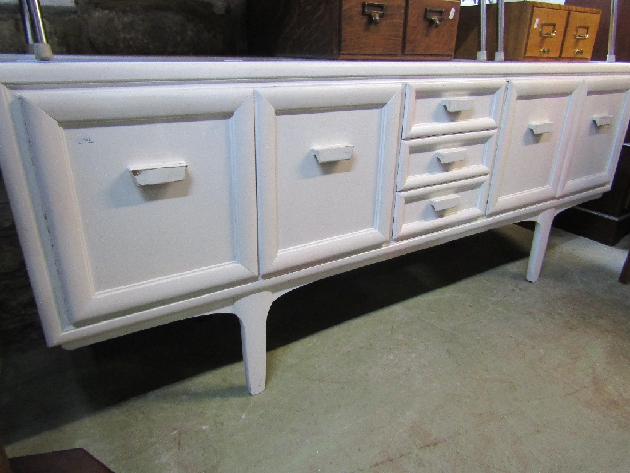 Appraisal: A mid th century long and low teak sideboard with