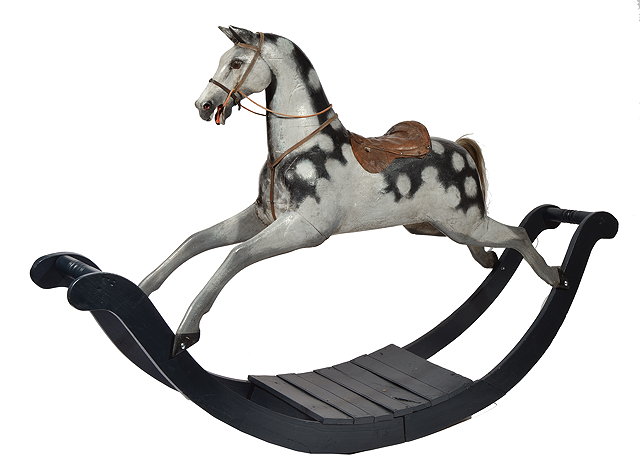 Appraisal: A VICTORIAN PAINTED CARVED WOODEN ROCKING HORSE with leather saddle