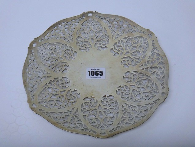 Appraisal: A silver shaped circular cake dish with scroll pierced decoration