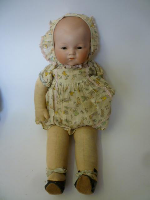 Appraisal: An Armand Marseille bisque head baby doll with brown glass