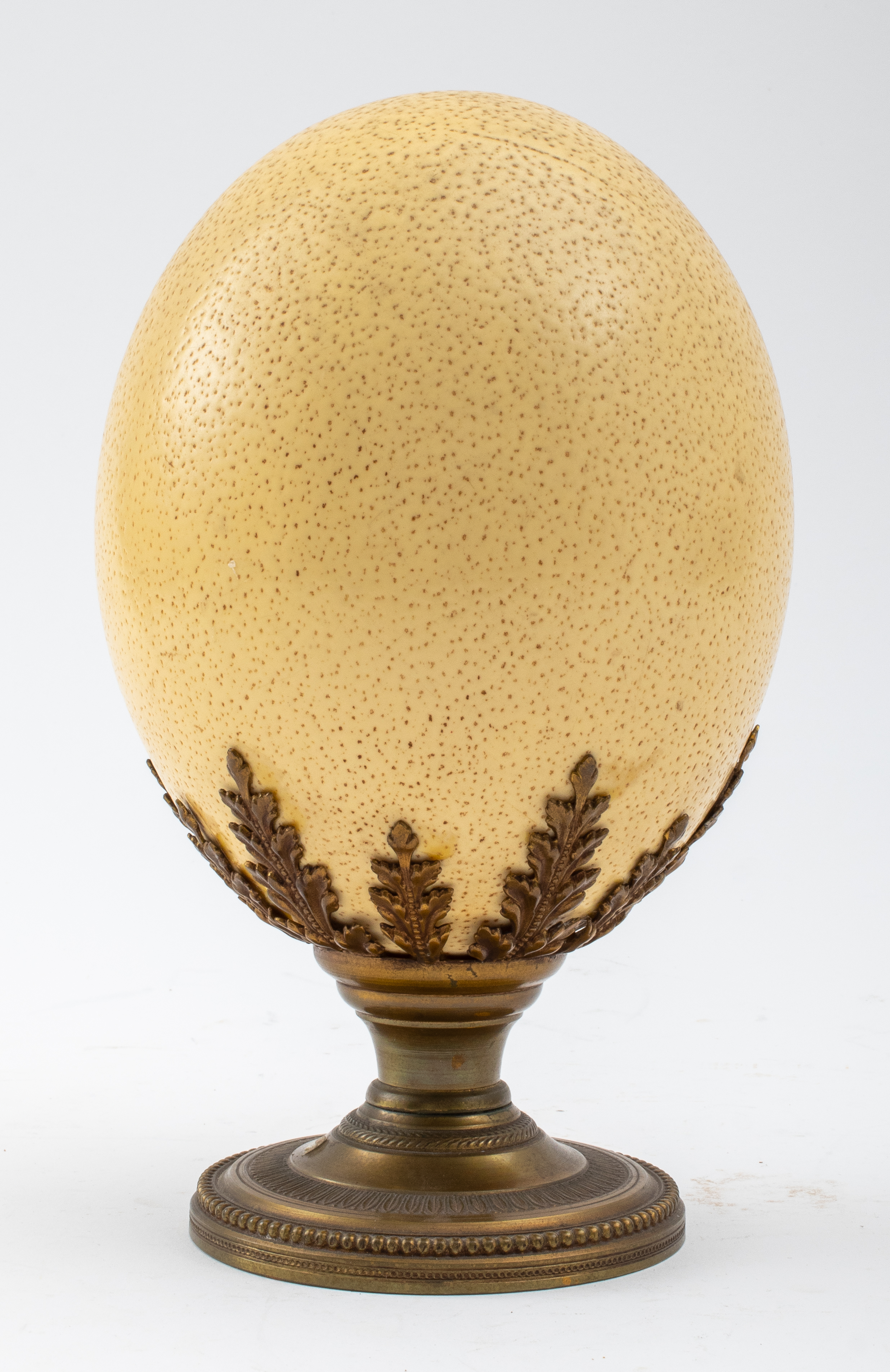 Appraisal: OSTRICH EGG ON BRASS STAND Ostrich egg on brass stand