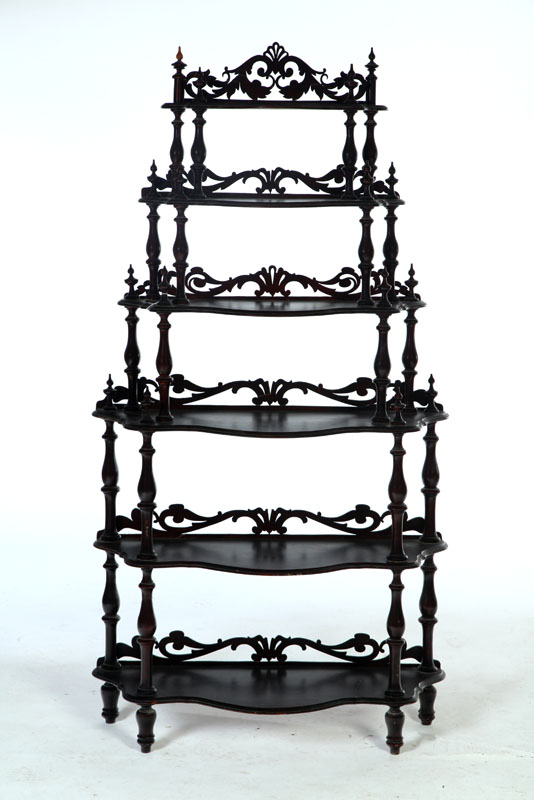 Appraisal: ETAGERE American late th century walnut Six shelves on turned