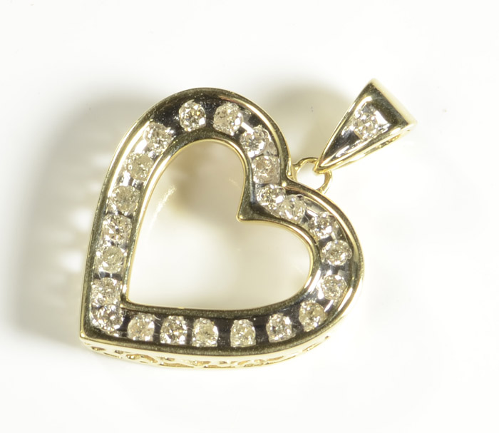 Appraisal: DIAMOND AND FOURTEEN KARAT GOLD PENDANT The open heart yellow