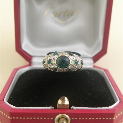 Appraisal: A diamond and cabochon emerald ring Centred with an oval