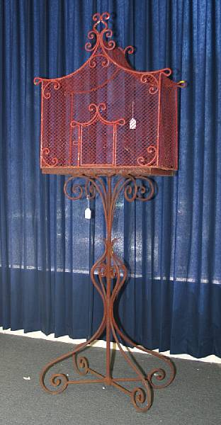 Appraisal: A red painted wire work and iron birdcage on stand