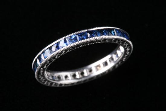 Appraisal: PLATINUM AND SAPPHIRE ETERNITY BAND Channel-set with cts square sapphires