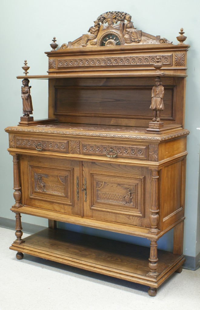 Appraisal: Carved oak continental sideboard brown marble top crest and bottom