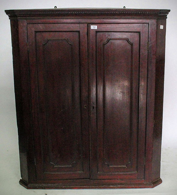 Appraisal: A GEORGE III MAHOGANY CORNER CABINET with dentil cornice above